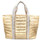Gold quilted tote bag with white trim on a white background
